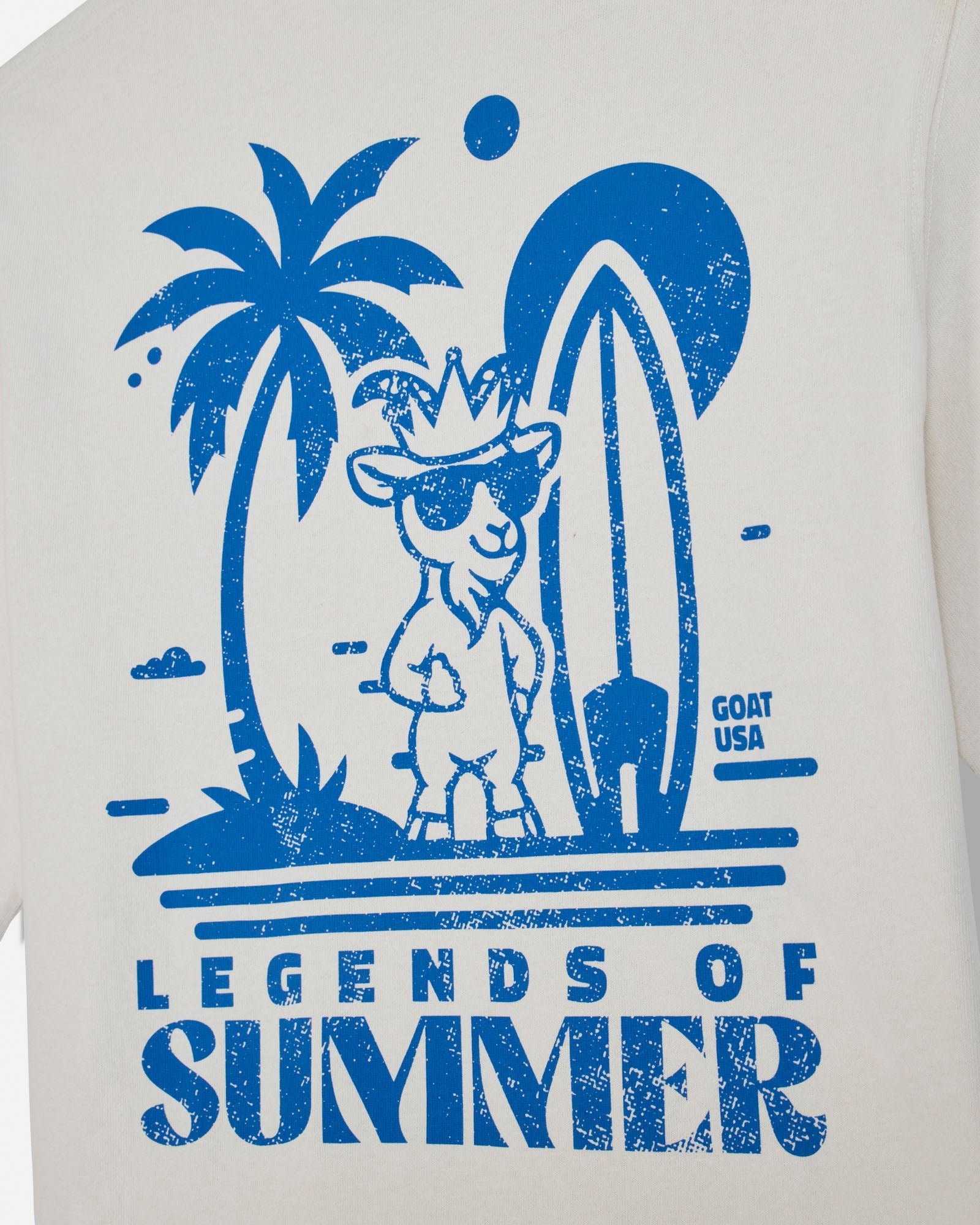 T-shirt with blue graphic of a goat with sunglasses, palm tree, and surfboard with 'Legends of Summer' text on a white background.