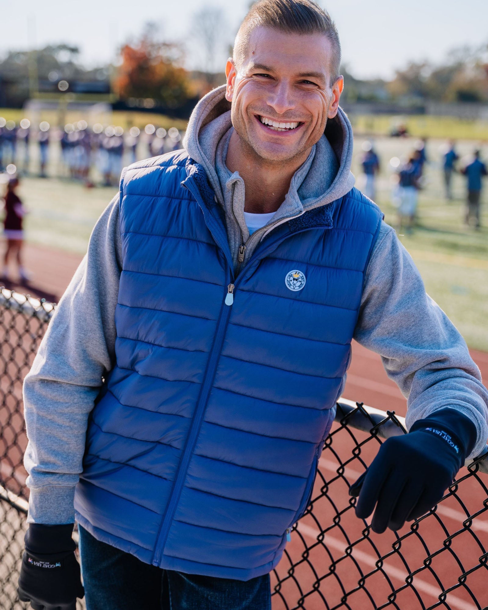 Model wearing navy Men's Puffer Fleece Vest#color_navy