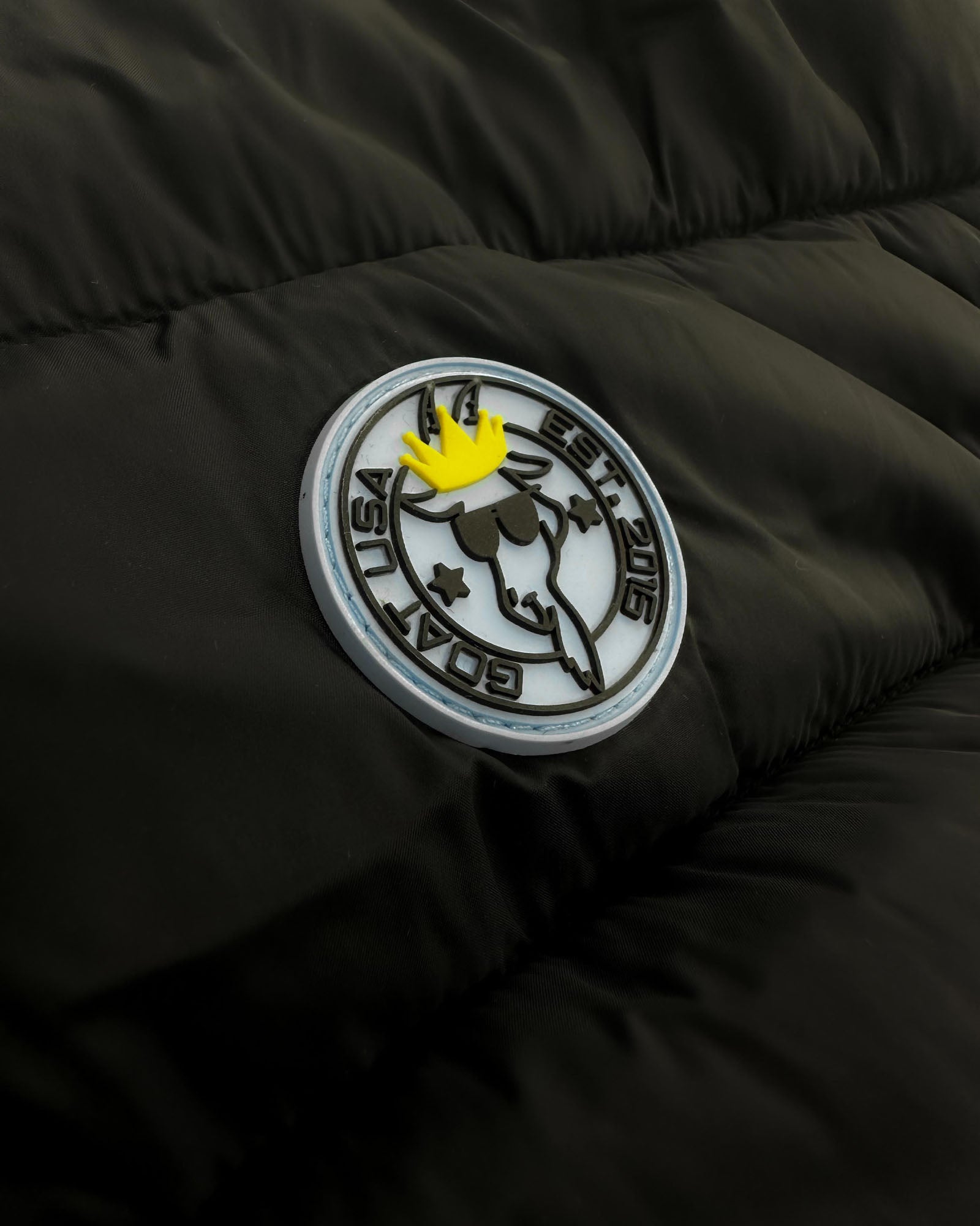 Close up of patch on black Men's Puffer Fleece Vest#color_black