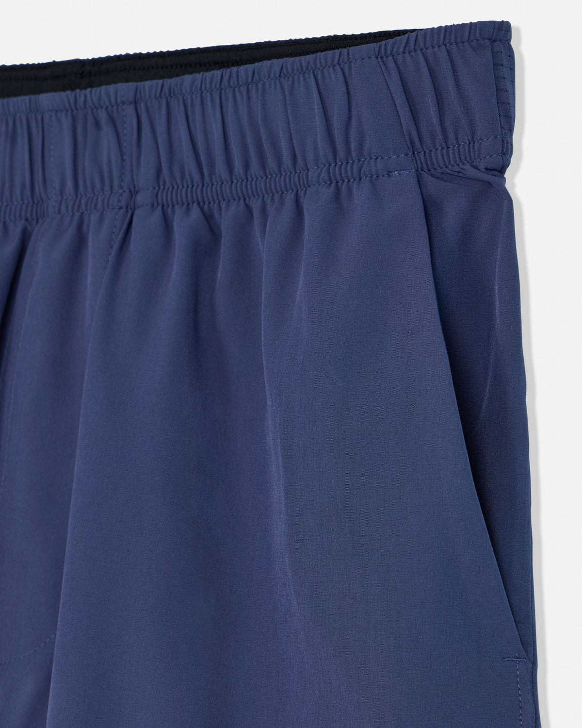 Close-up of blue shorts with an elastic waistband on a white background