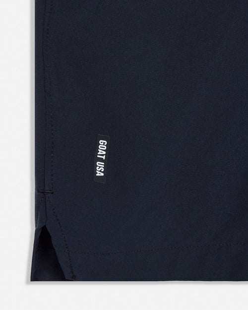 Close-up of a black garment with a small label on a white background#color_black
