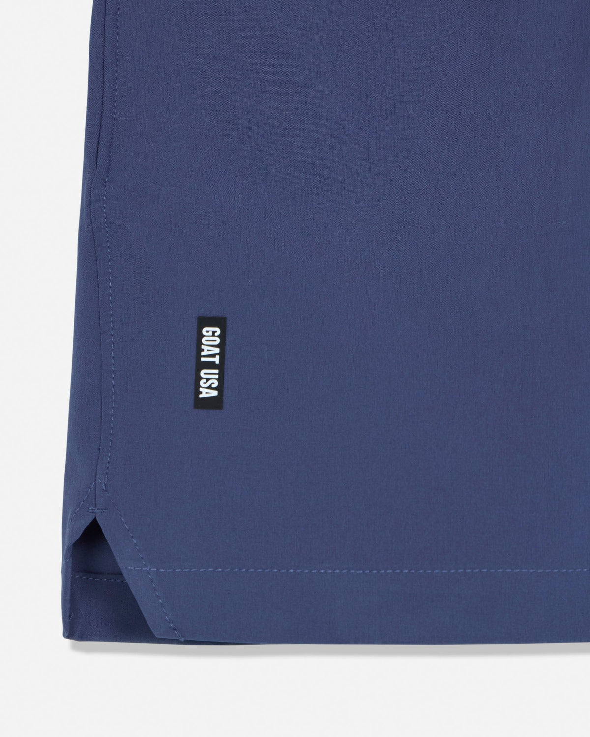 Navy blue fabric with a small black label on a white background