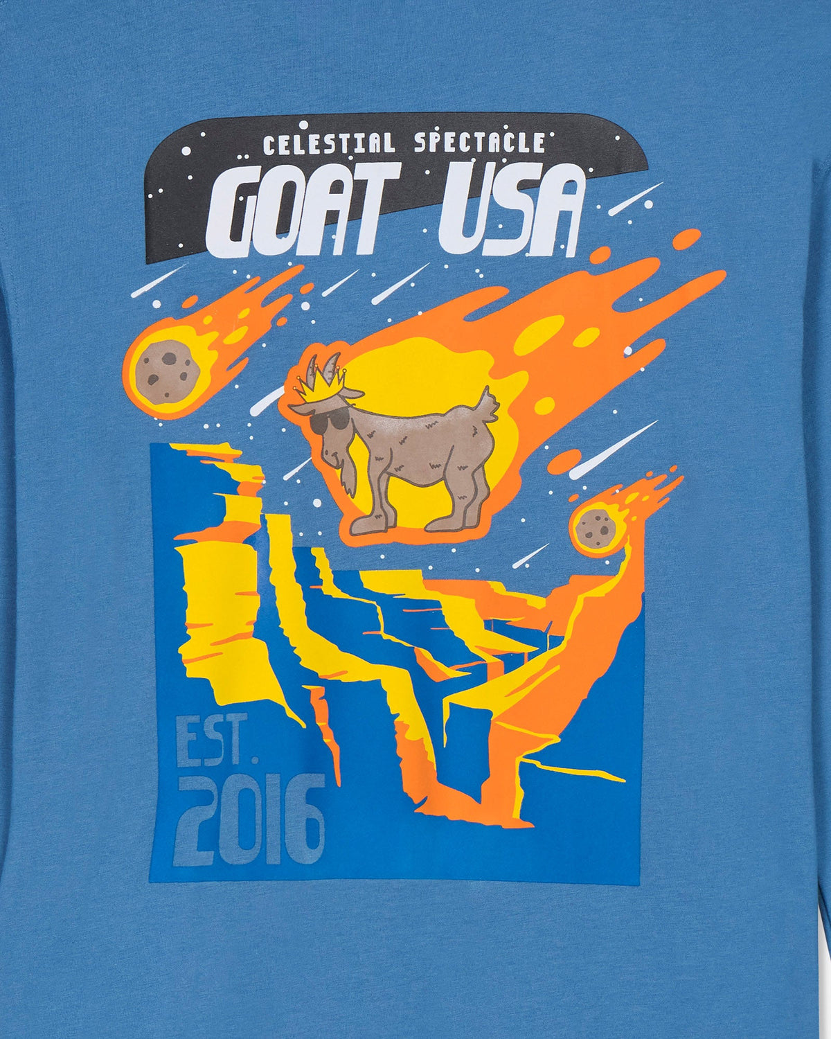 Blue t-shirt with a graphic design of a goat, comets, and 'GOAT USA' text.