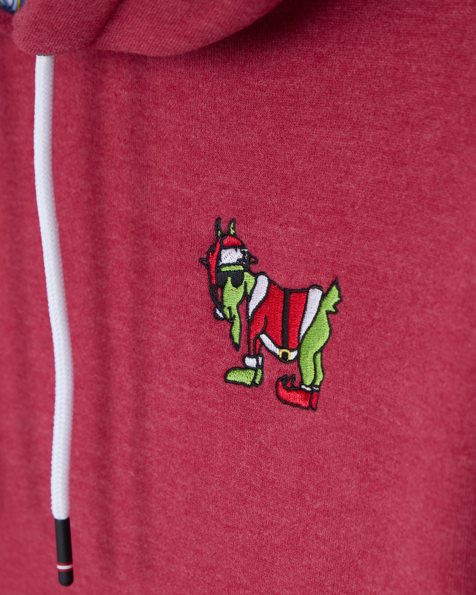Red hoodie with a cartoon character wearing a Santa hat and red shoes on a red background