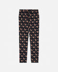 Black pajama pants with an all-over repeating print of colorful green goat santas, shown flat against a light gray background.