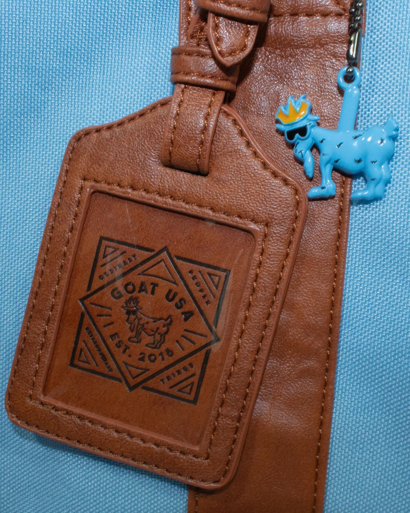 Luggage tags on carolina blue OG Duffel Bag#color_carolina-blue