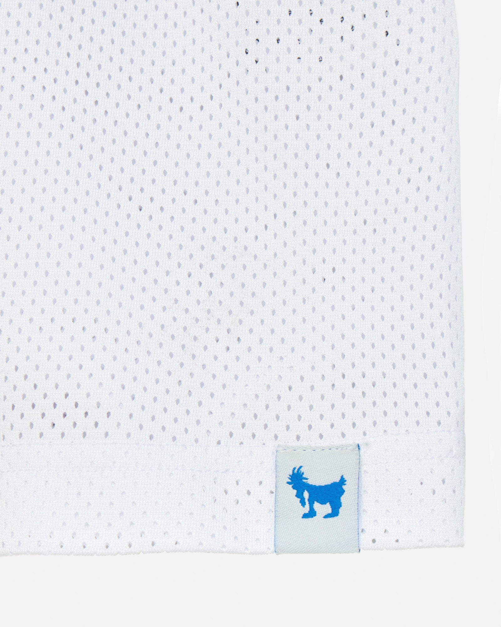 White perforated fabric with a blue logo tag featuring a goat icon on a light gray background