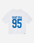 White t-shirt with blue text 'GOAT USA 95' on a light gray background