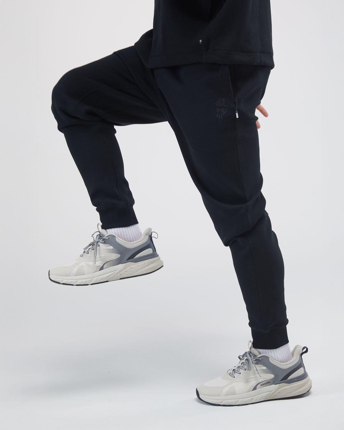 black performance joggers on model focused on legs#color_black