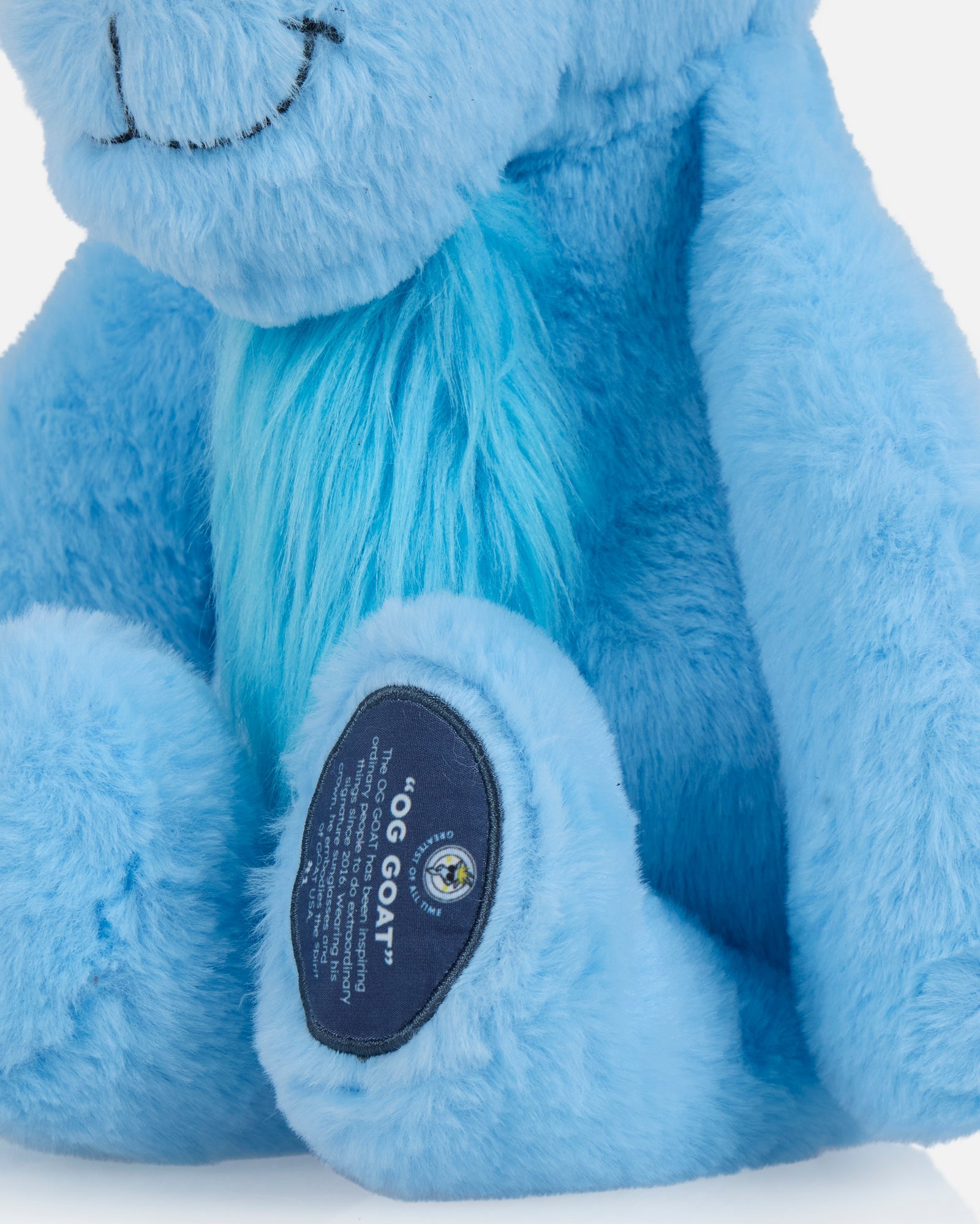 Close up of blue goat plushie