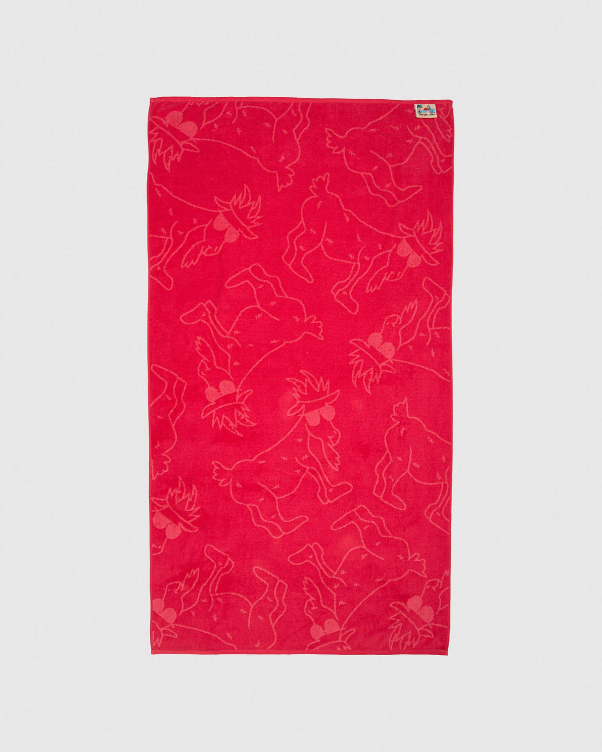 Red beach towel with salmon-colored goats
