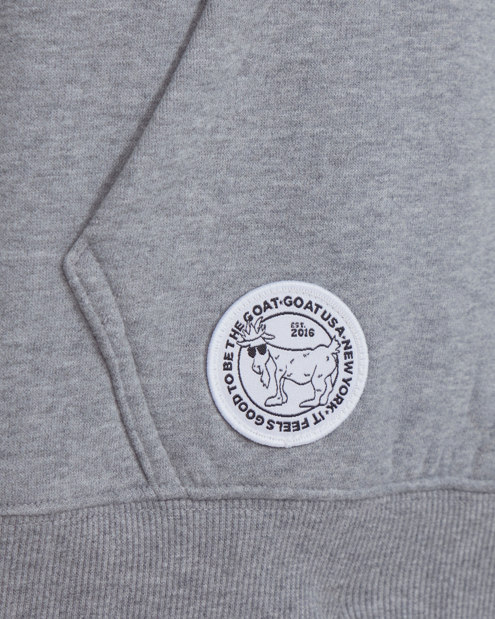 Gray hoodie with a circular logo featuring a goat and text on the chest.