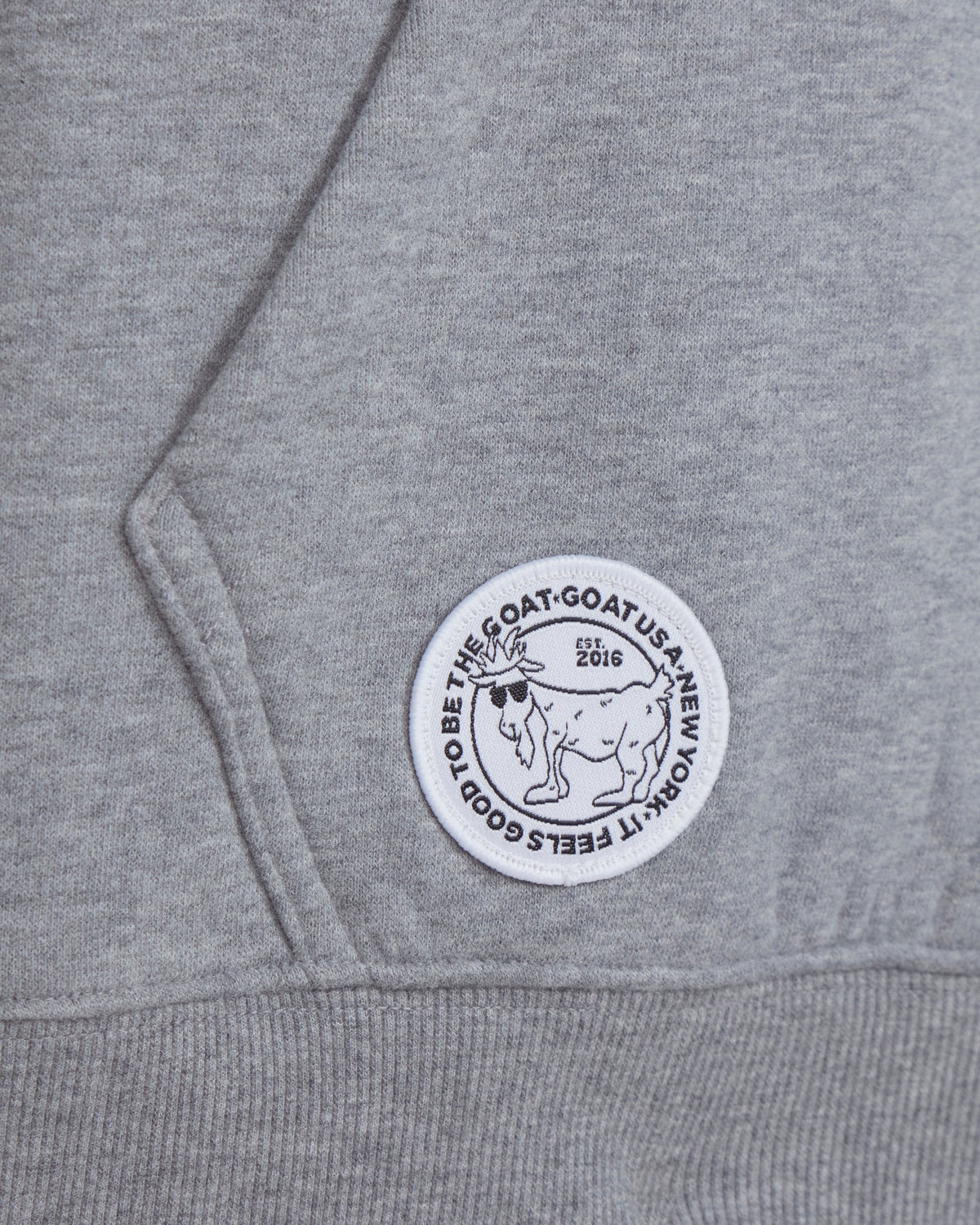 Gray hoodie with a circular logo featuring a goat and text on the chest.