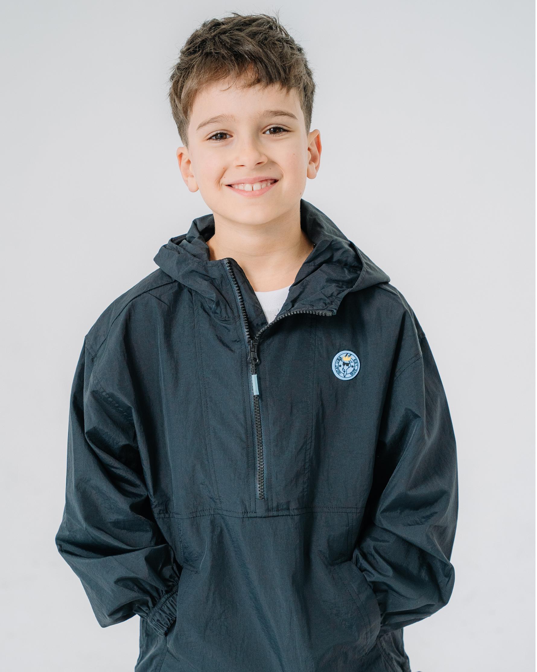 Boy wearing black windbreaker#color_black