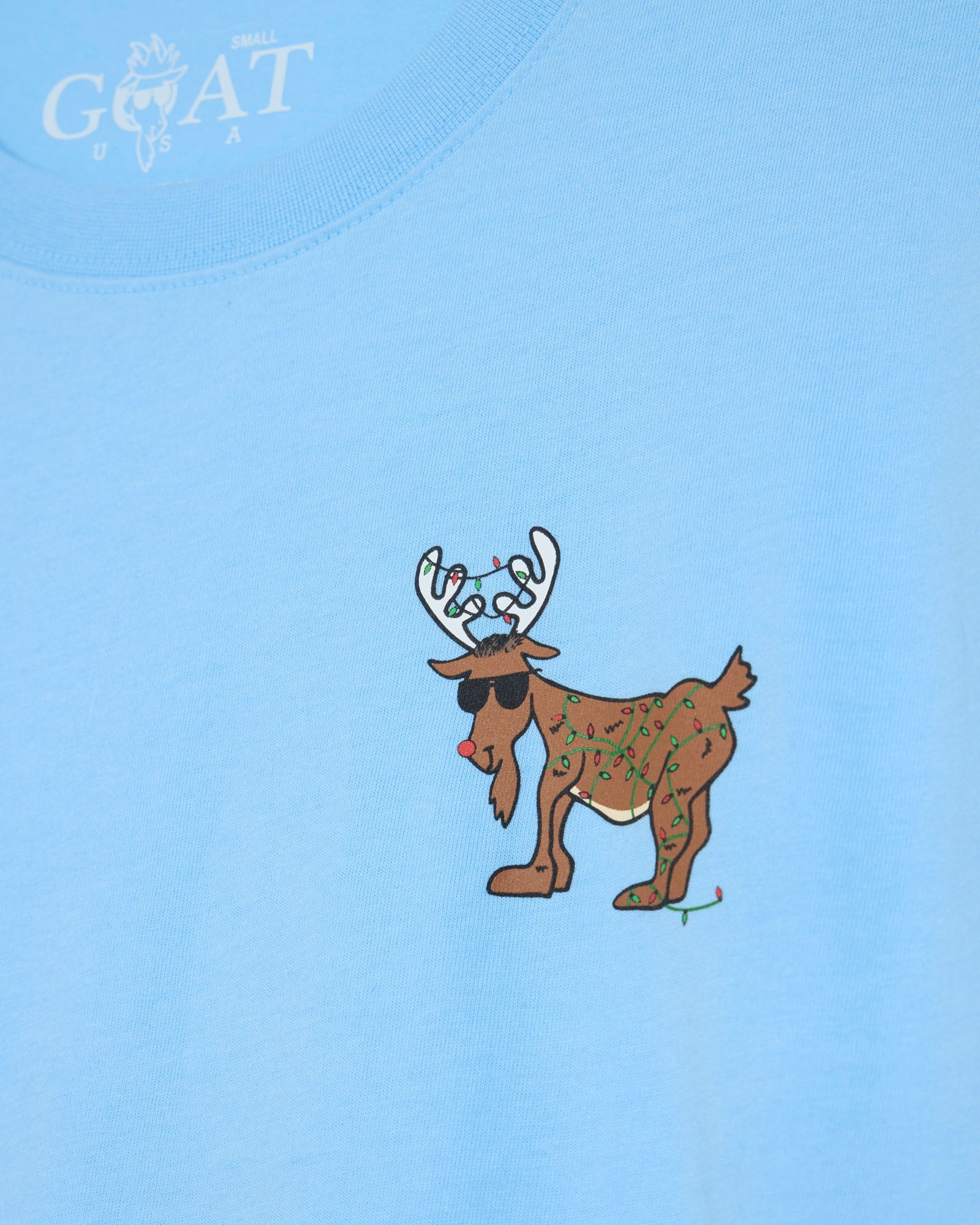 Light blue t-shirt with a reindeer graphic and 'GOAT' branding