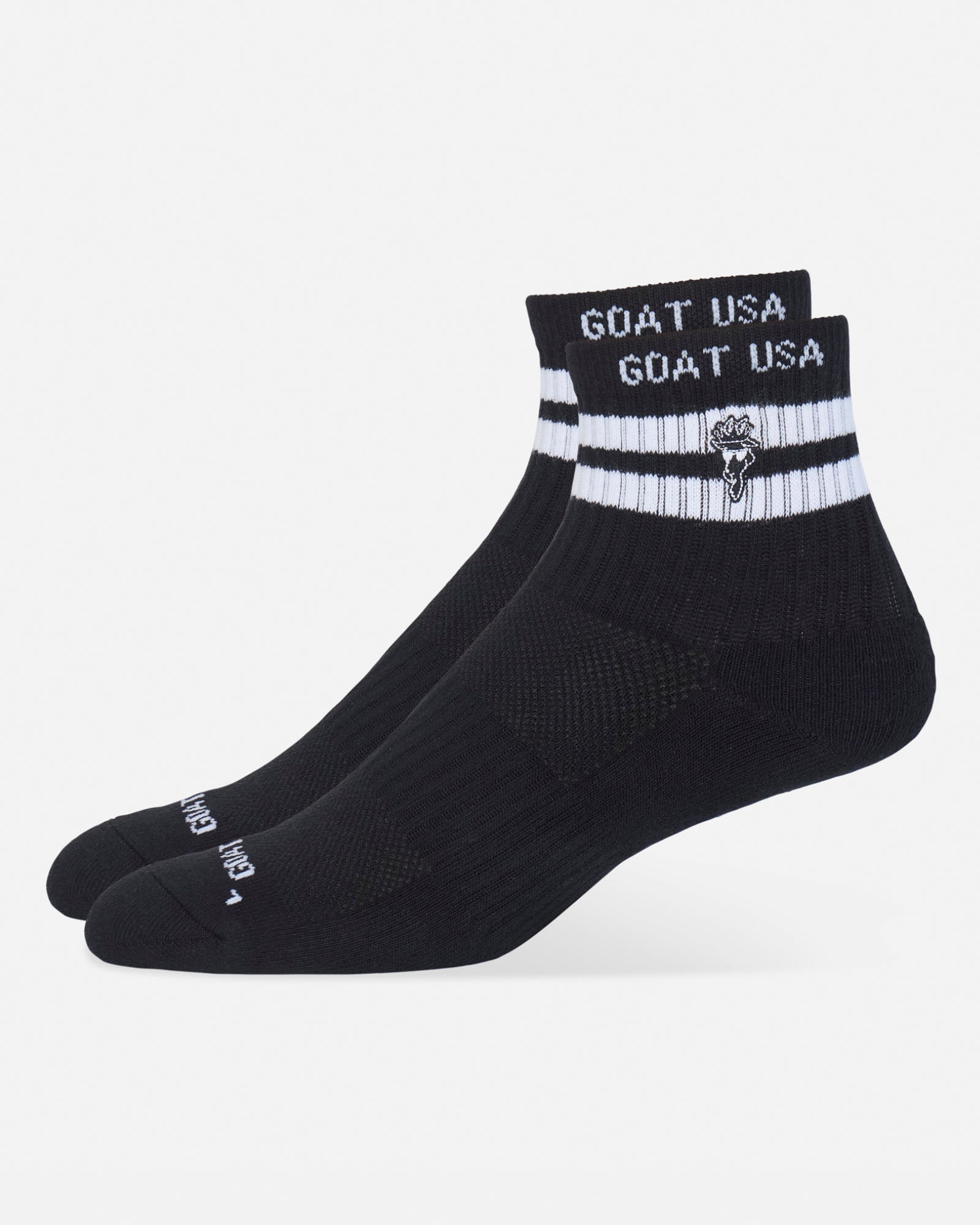 A pair of black ankle socks with white stripes and 'GOAT USA' branding on the cuff, displayed against a light gray background.#color_black