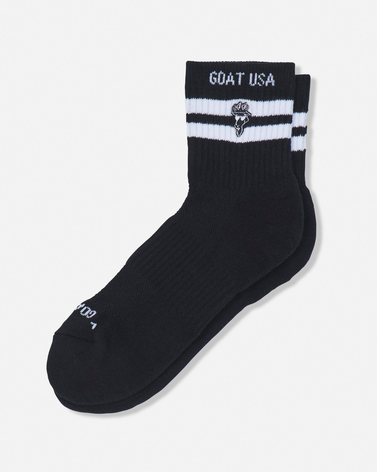 A pair of black mid-calf athletic socks with white stripes and 'GOAT USA' branding on the cuff, displayed against a light gray background.#color_black