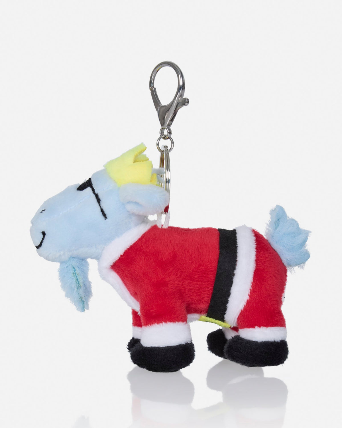 A plush goat character keychain dressed in a red Santa-style suit with white and black trim, a yellow crown, and a silver lobster clasp at the top, shown on a light gray background.