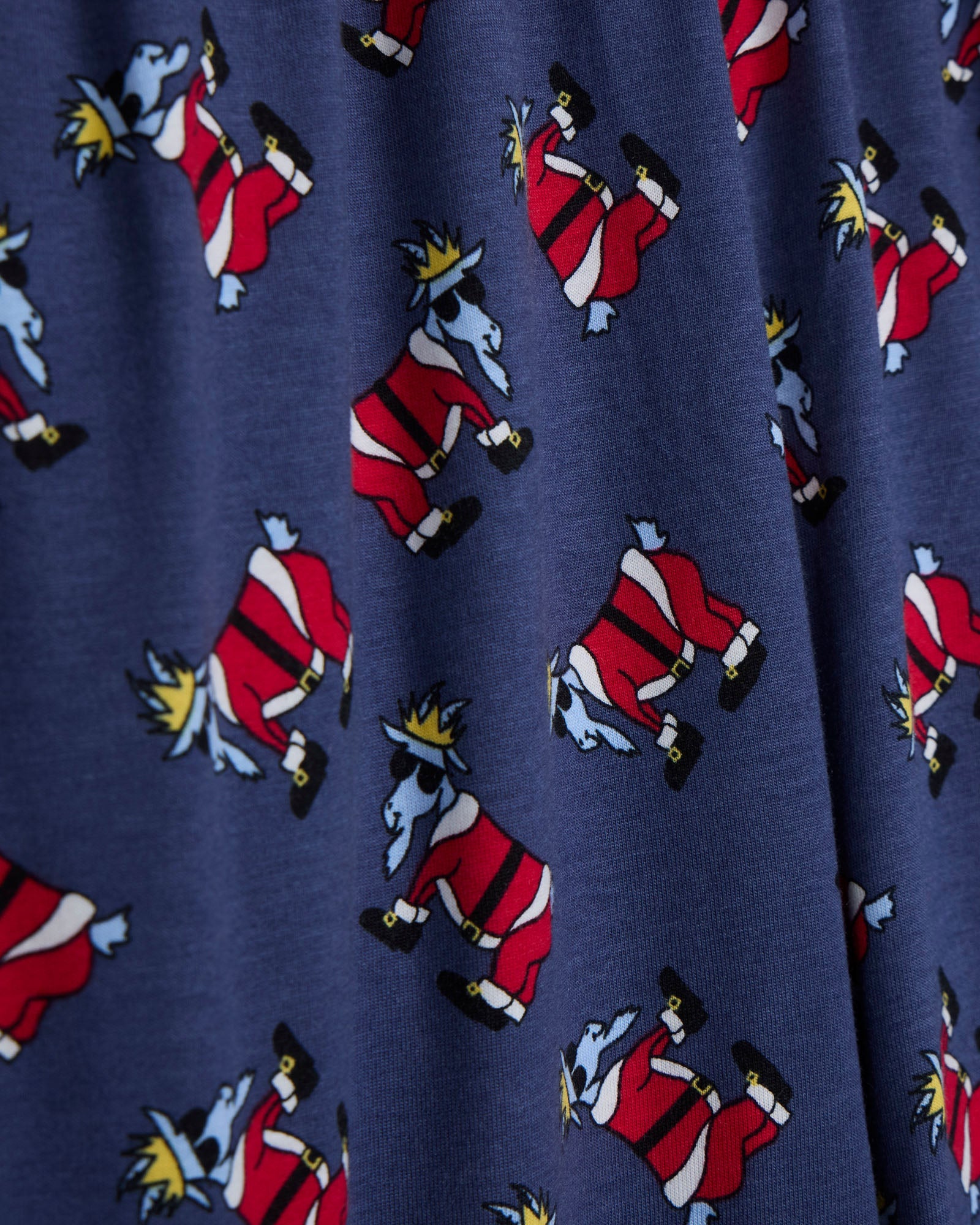 Navy fabric with a pattern of cartoon santa goats.