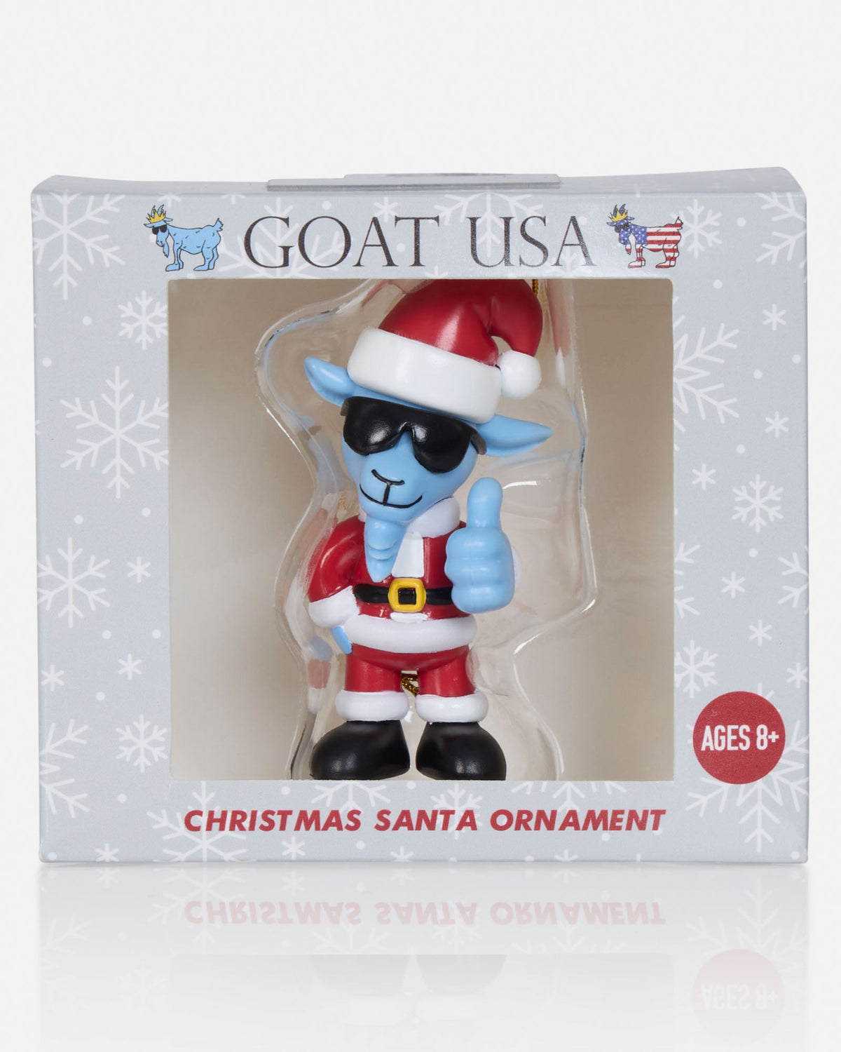 A Christmas Santa ornament figurine by Goat USA, packaged in its original white window box. The ornament depicts a goat dressed in a Santa suit with a red hat, black sunglasses, and a thumbs-up gesture.