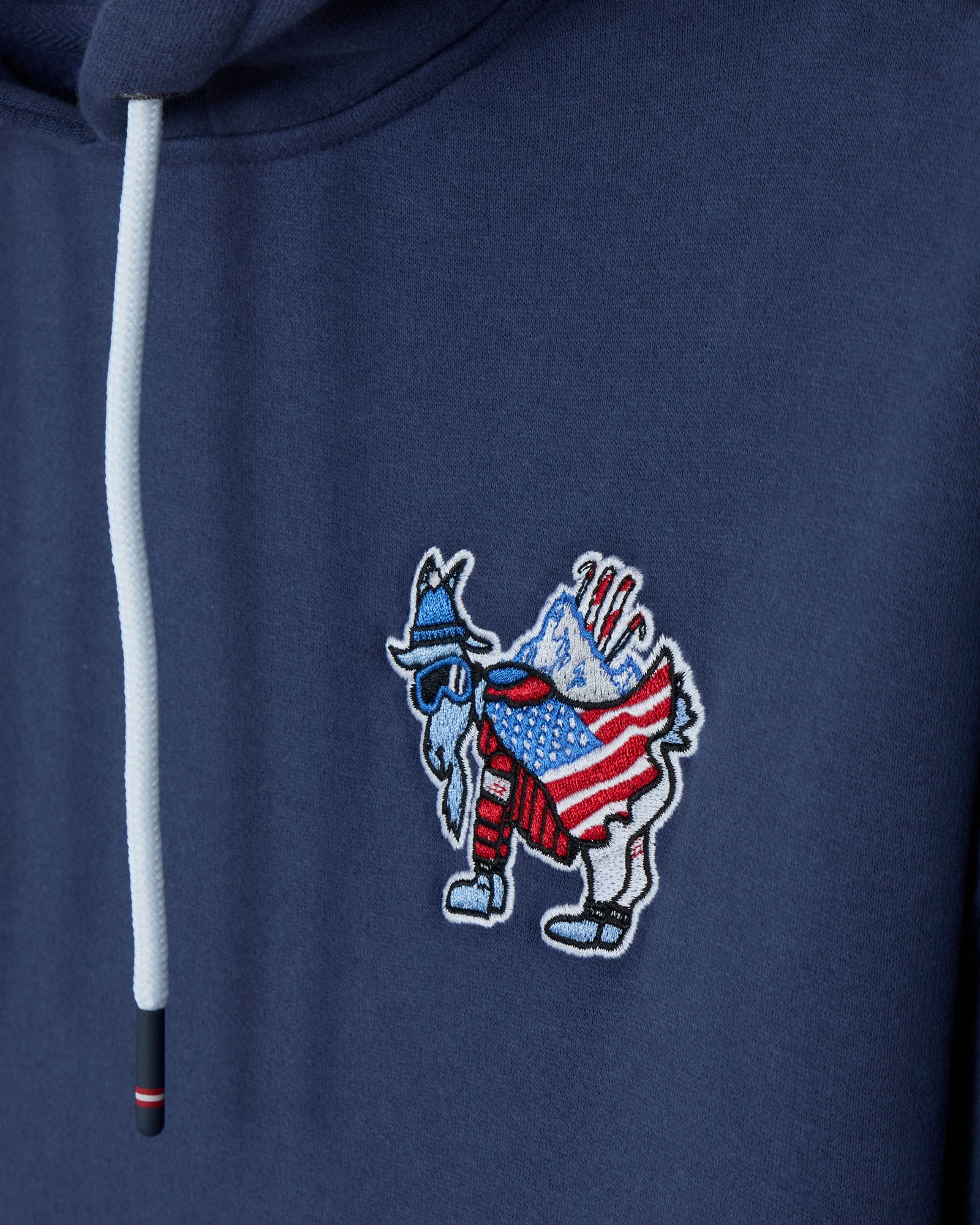 Navy blue hoodie with a colorful embroidered patch on the chest.