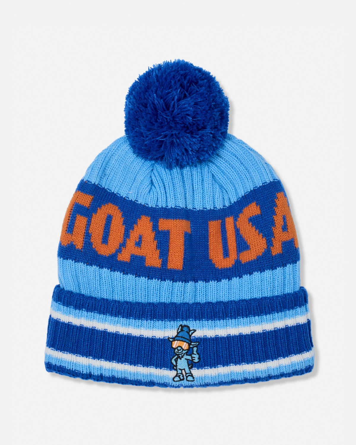 A blue and light blue knit beanie hat with a large blue pom-pom on top. The front has bold orange lettering that reads 'GOAT USA' and a small cartoon mascot embroidered near the bottom of the cuff.