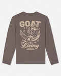 A long-sleeve crewneck t-shirt in a muted brownish-gray color, featuring a large beige graphic print on the back with a cartoon goat in a hammock and the text 'GOAT USA Living JUST ENJOY EVERY MOMENT'.