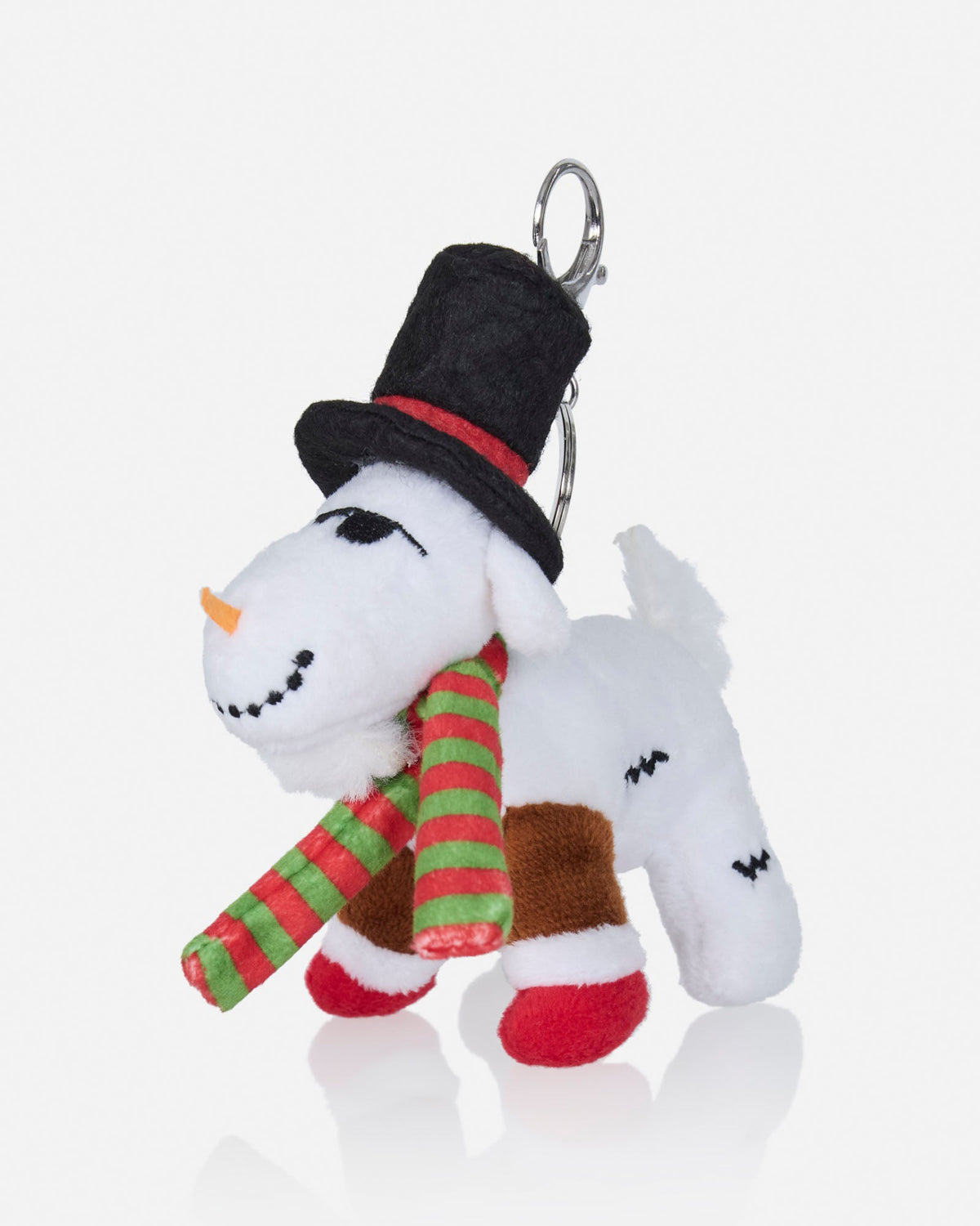 A plush goat keychain charm dressed as a snowman, wearing a black top hat with a red band, a red and green striped scarf, and red-and-white striped socks, attached to a silver metal key ring on a light gray background.