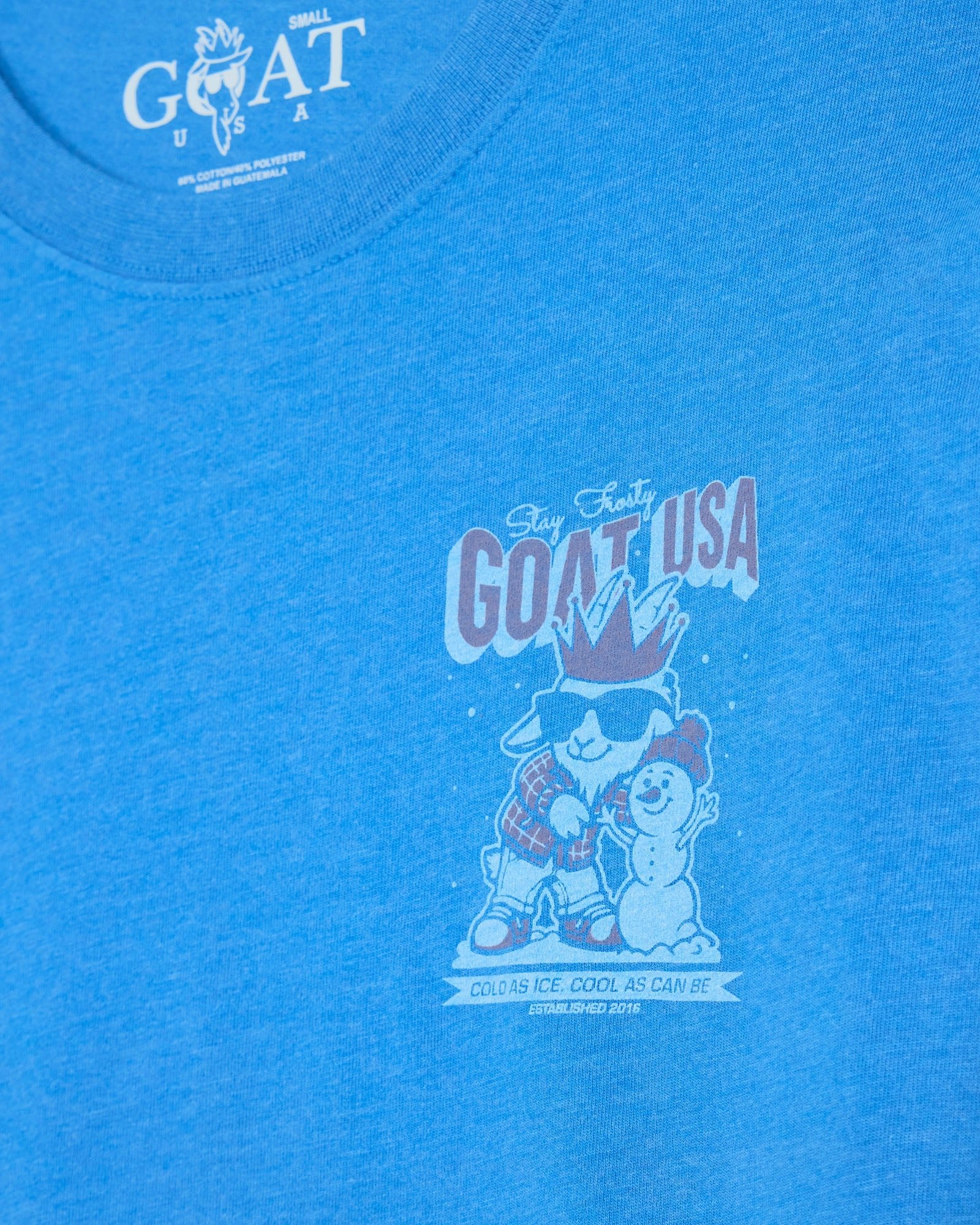 Blue t-shirt with 'GOAT USA' graphic design featuring cartoon characters and text.