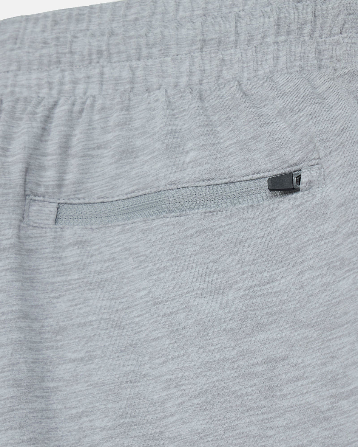 Close-up of gray shorts with a zipper pocket