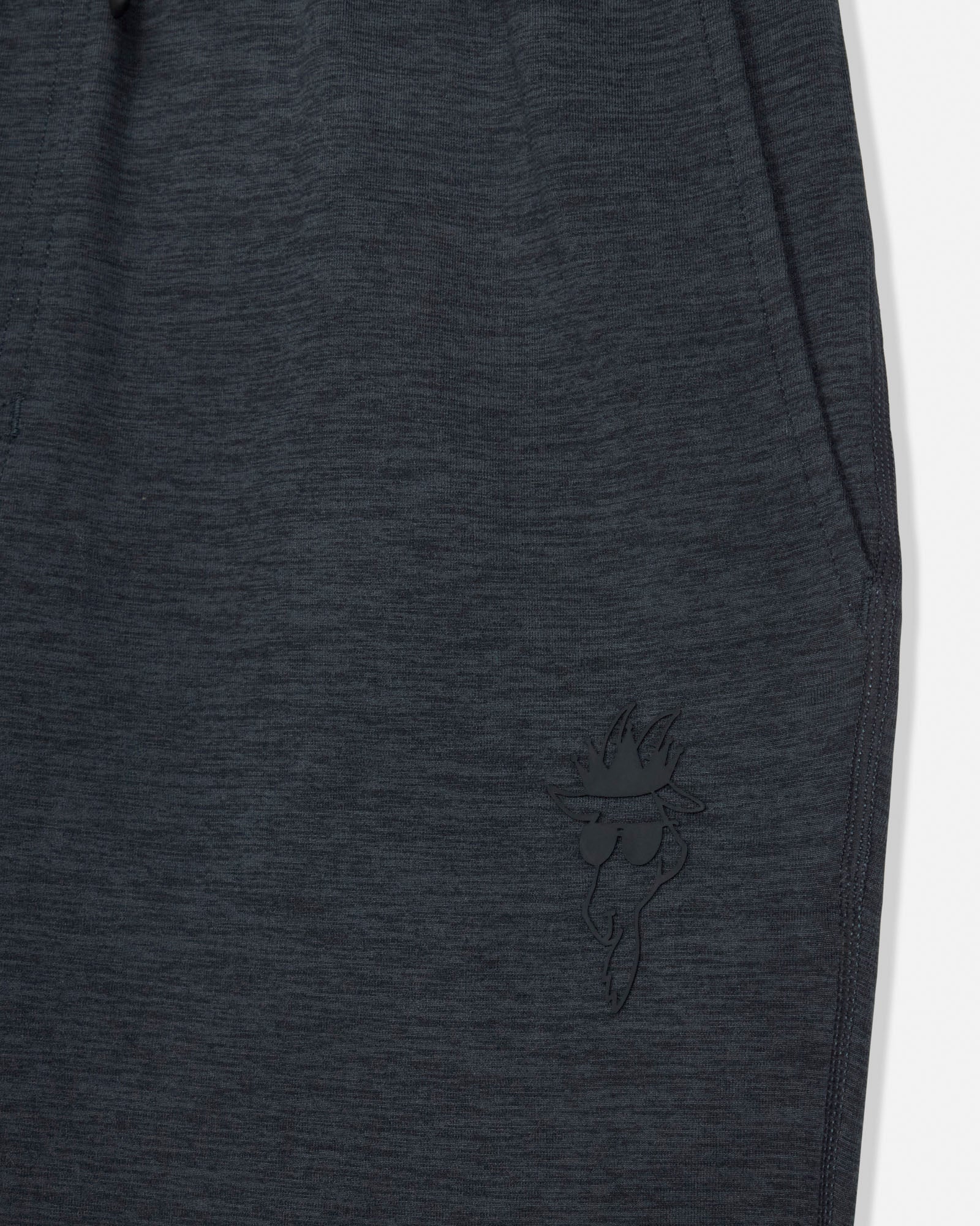 Dark gray sweatpants with a small embroidered design on a white background#color_space-dye-black