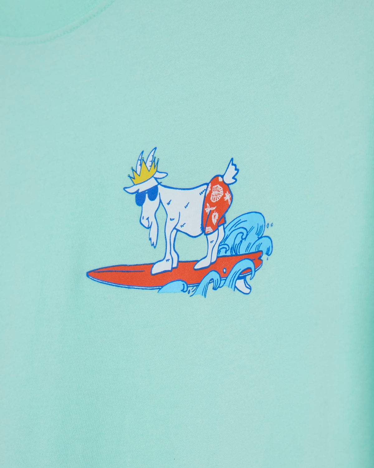 Illustration of a goat with a crown surfing on a wave, on a mint background.