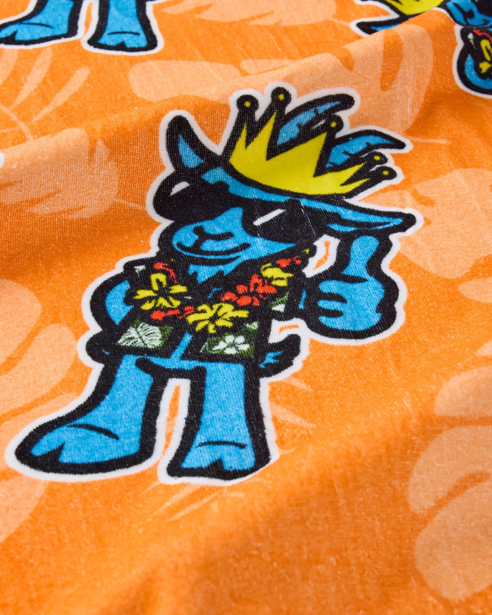 Blue cartoon character with a crown on an orange floral background