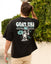 Person wearing a black 'GOAT USA' t-shirt with a graphic design on the back, standing outdoors.
