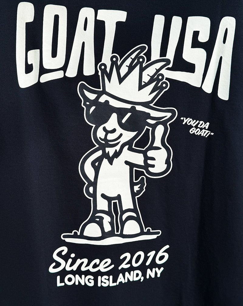 Navy t-shirt with white graphic and text 'GOAT USA' and 'Since 2016 LONG ISLAND, NY'.
