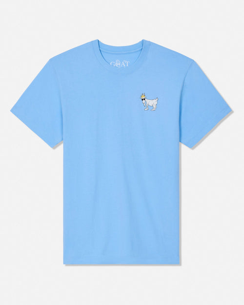 A light blue short-sleeve crewneck t-shirt with a small embroidered cartoon goat on the left chest, displayed flat against a light gray background.