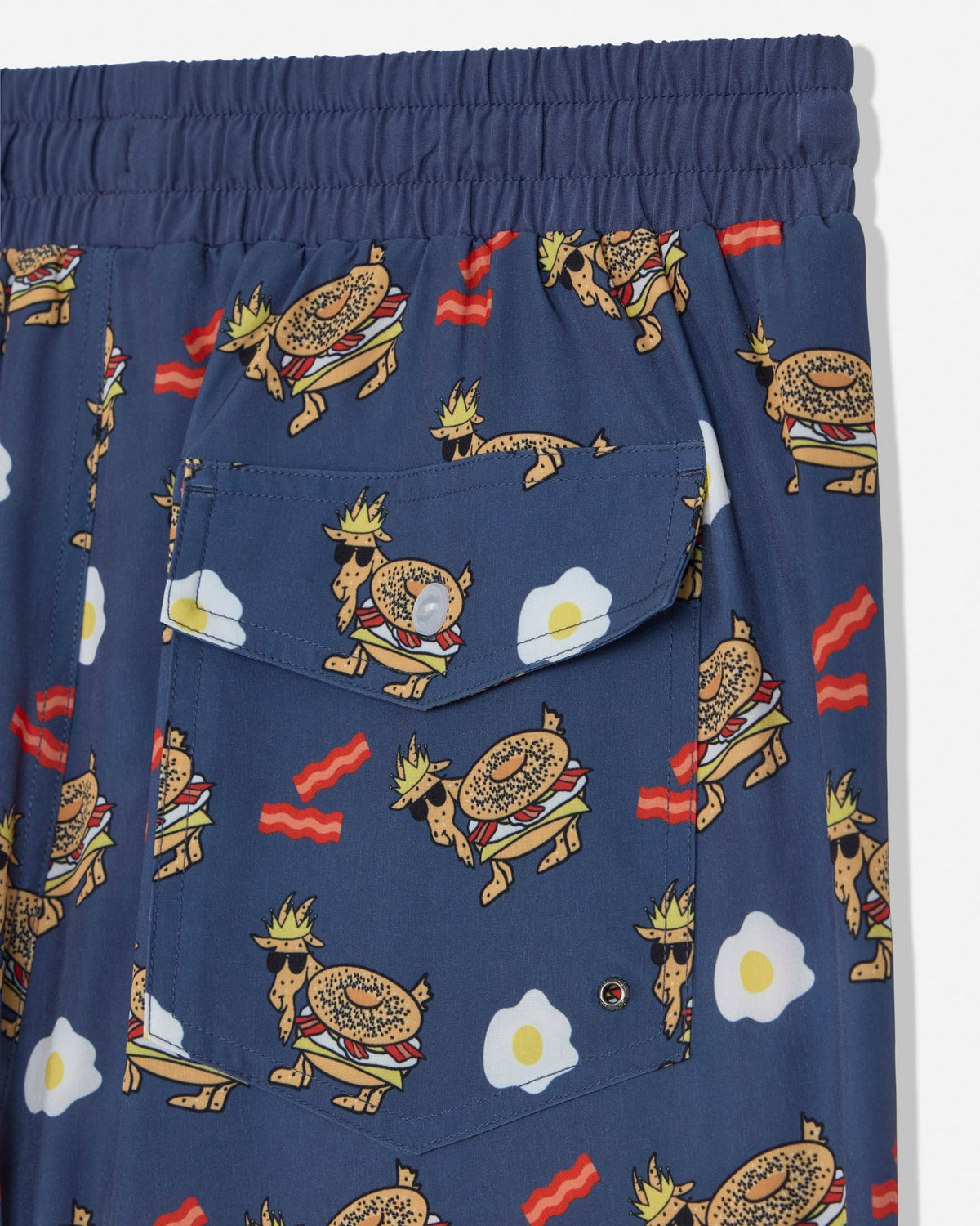 Navy shorts with cartoonish egg sandwich goat pattern on a white background