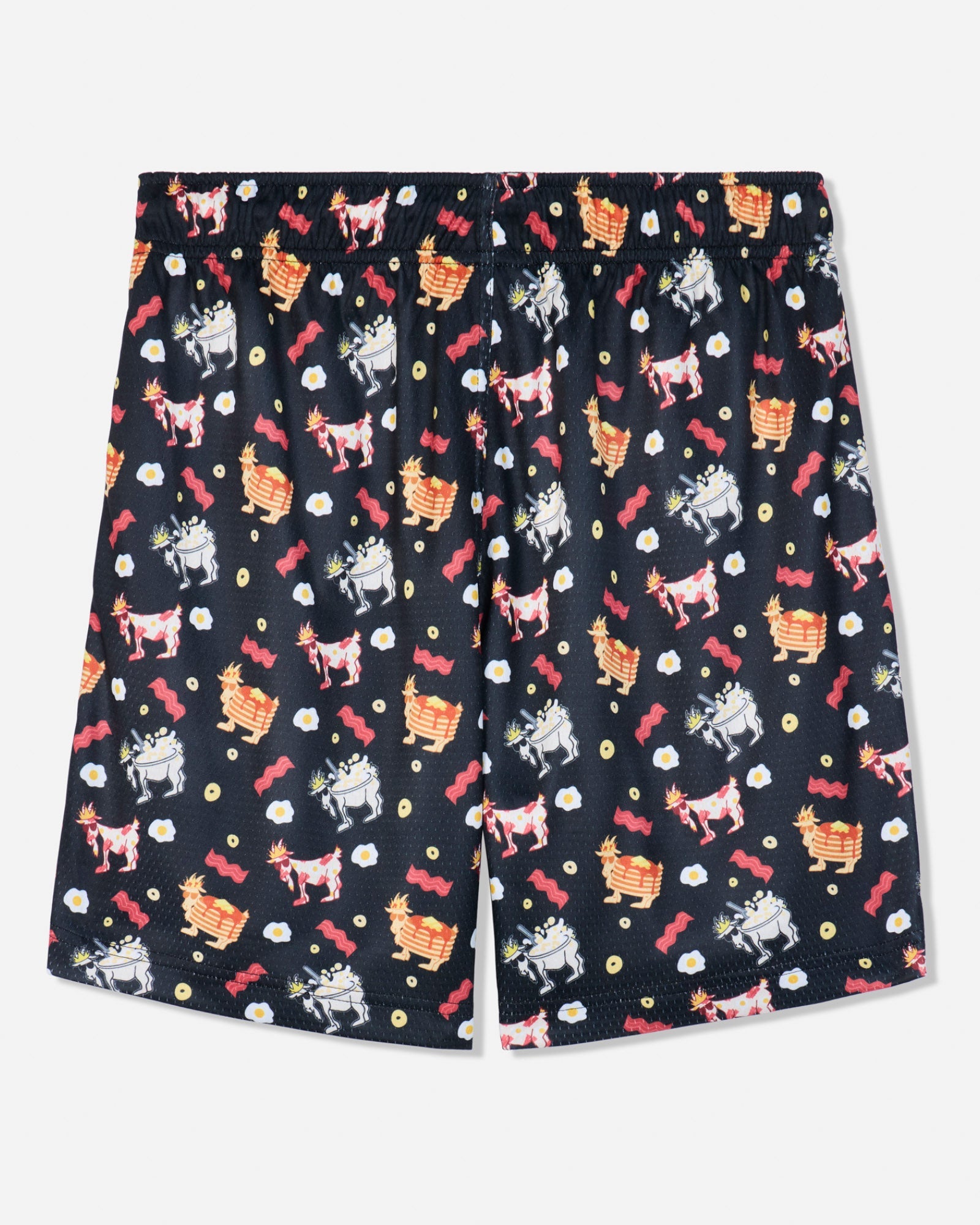 A pair of black shorts featuring an all-over whimsical pattern of cartoon goats, red roses, and small white flowers, displayed flat against a light gray background.