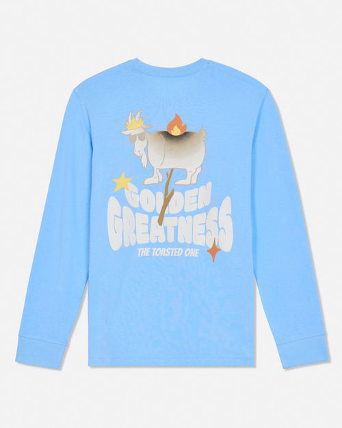 A light blue long-sleeve t-shirt with a graphic on the back featuring a cartoon goat on fire and the text 'GOLDEN GREATNESS THE TOASTED ONE'.