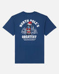 A navy blue short-sleeve t-shirt with a large graphic on the back. The graphic features the text 'NORTH POLE'S GREATEST' in white, a cartoon Santa Claus character, and a small winter village illustration.