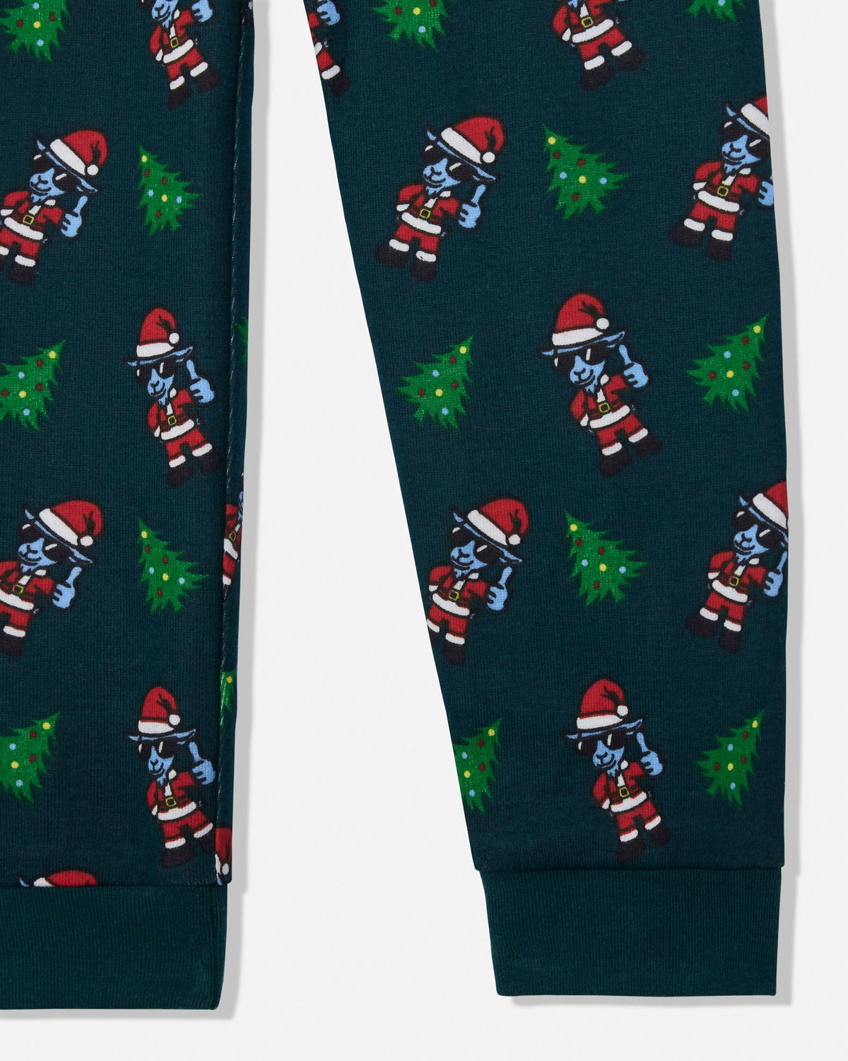Dark teal blue pajama pants featuring a repeating Christmas-themed pattern of cartoon characters in Santa suits and green Christmas trees, shown on a white background.