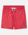 Red swim trunks with a white snowflake pattern, featuring a white drawstring and a small embroidered goat logo on the lower left leg, shown against a plain light gray background.