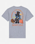 A heather gray short-sleeve t-shirt shown from the back, featuring a colorful graphic of a blue goat dressed as a pilgrim with pumpkins, a turkey, and autumn leaves, with the text 'THANKFUL FOR BEING THE GOAT' and 'GOATUSA'.