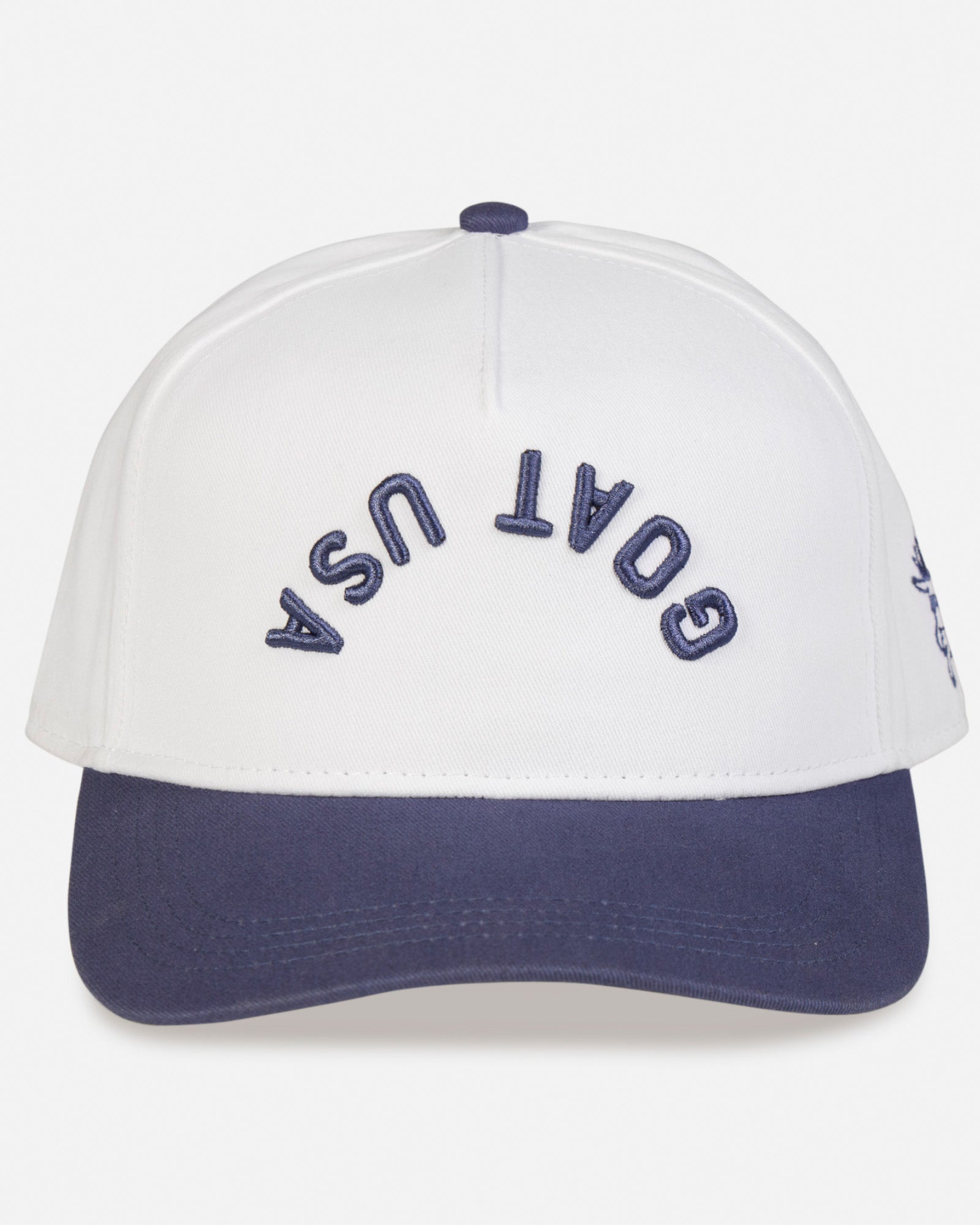 Front of white and navy hat with "GOAT USA" written upside down