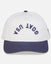 Front of white and navy hat with "GOAT USA" written upside down