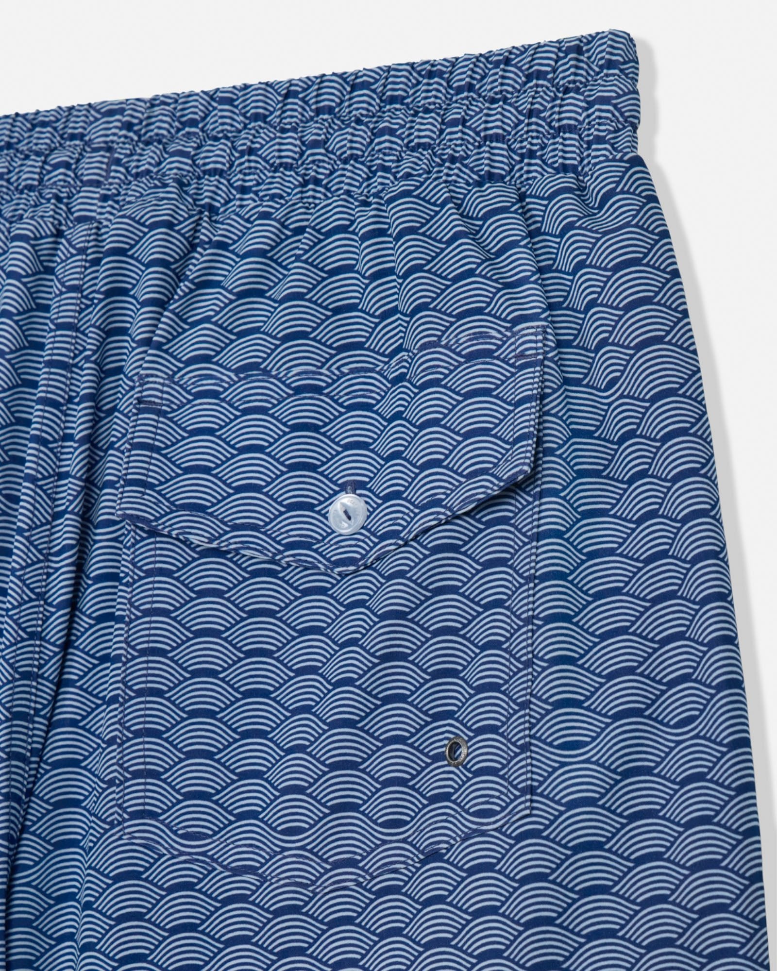 Blue patterned shorts with a pocket on a white background