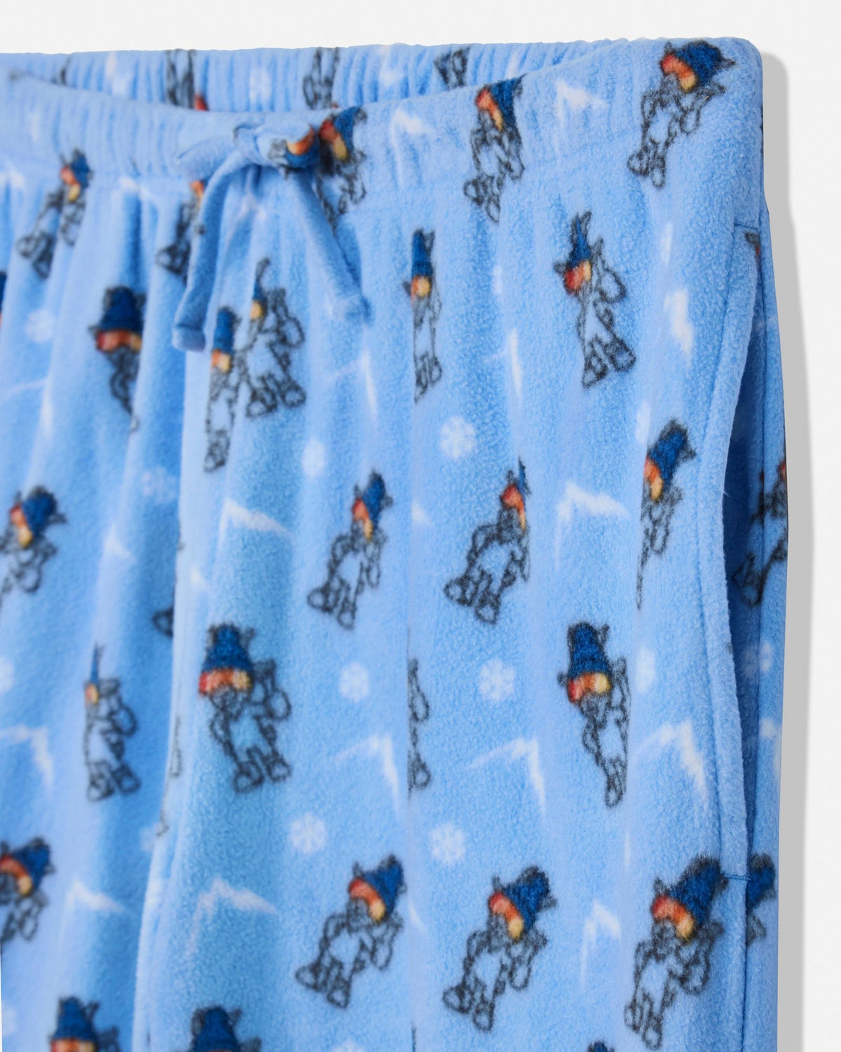 Close-up of light blue fleece pajama pants with an allover cartoon goat print and a drawstring waistband.