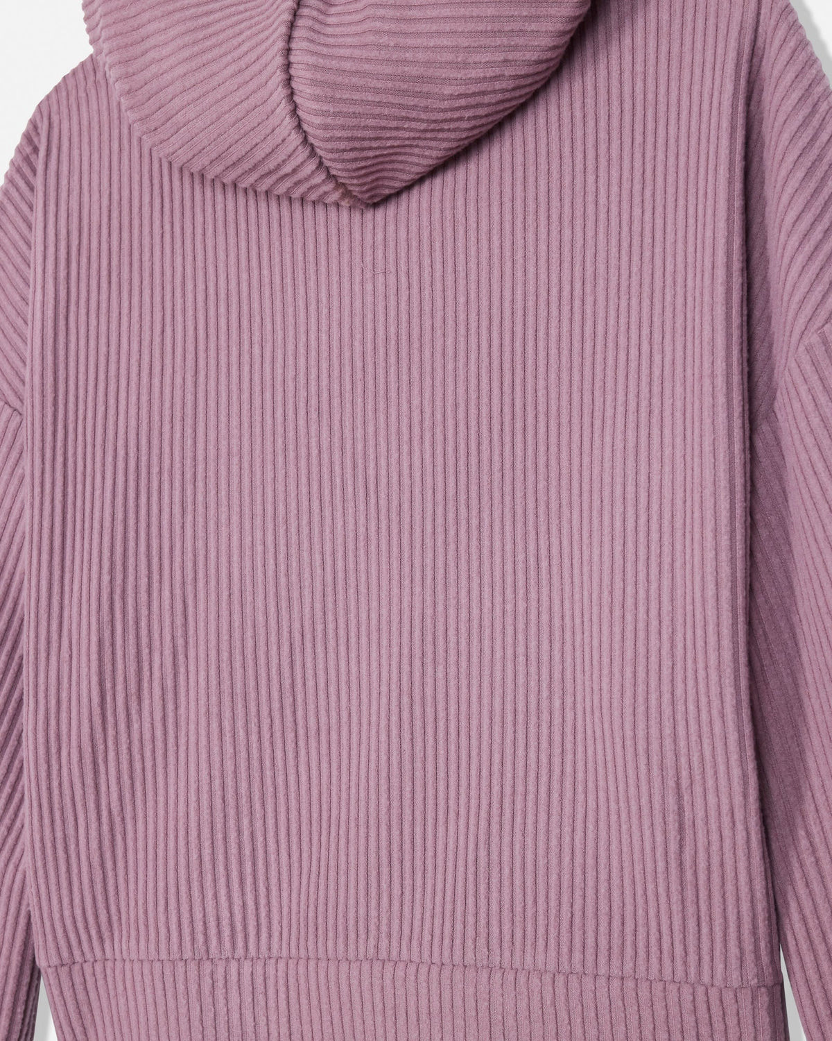 Close-up of a ribbed knit hoodie in a dusty mauve-pink color, showing the texture of the fabric and the hood.
