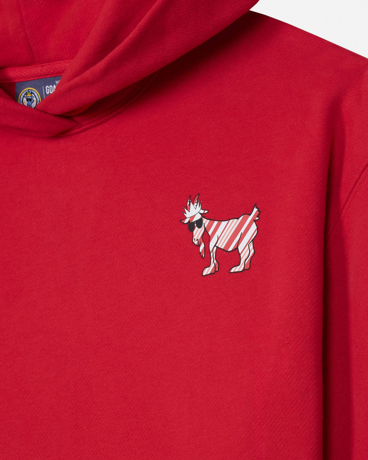 A close-up of a bright red hoodie featuring a small embroidered goat graphic on the left chest with diagonal red and white stripes.