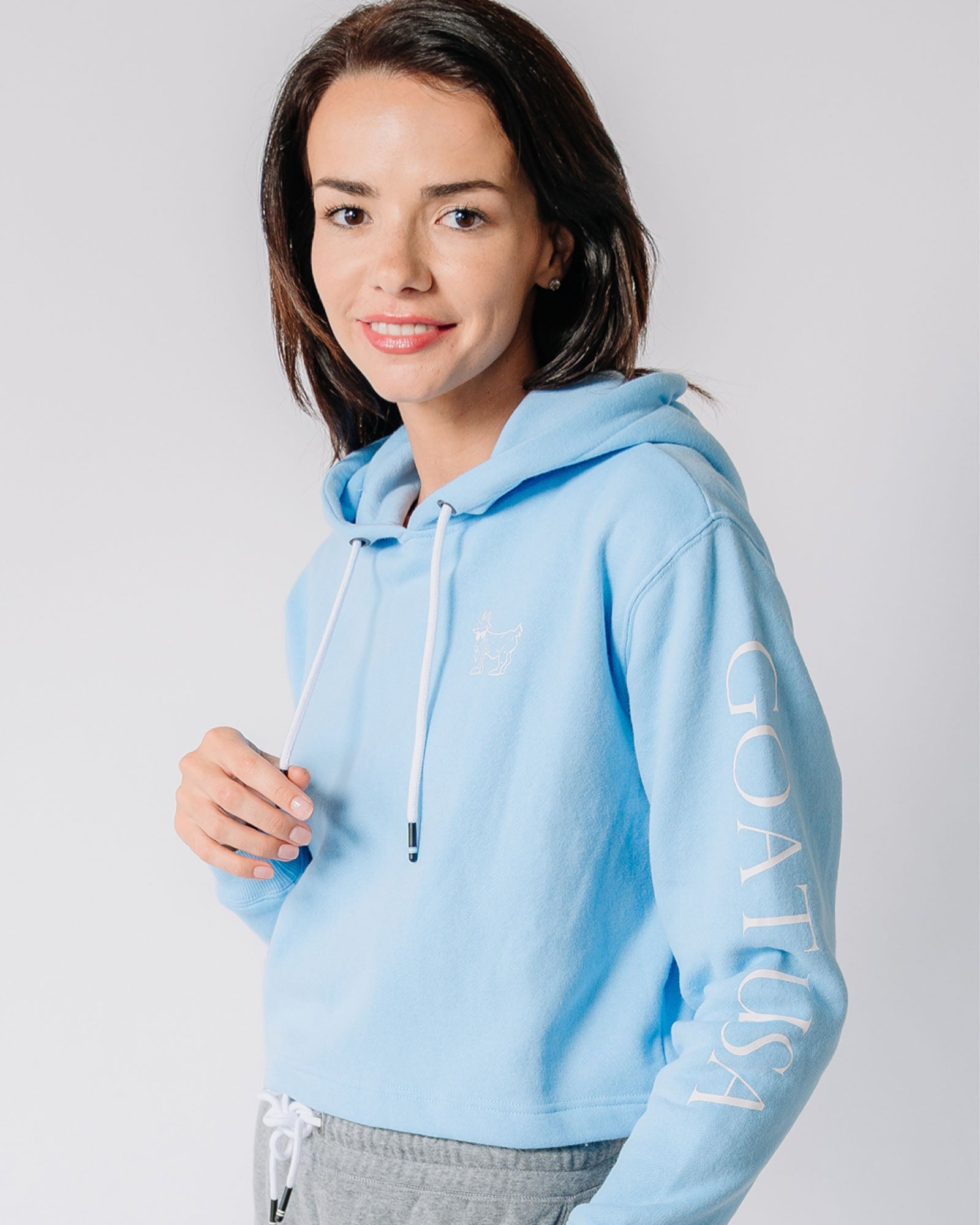 Model wearing carolina blue Women's OG Cropped Hooded Sweatshirt#color_carolina-blue